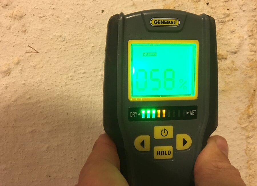Moisture meter reading being taken on an exterior wall